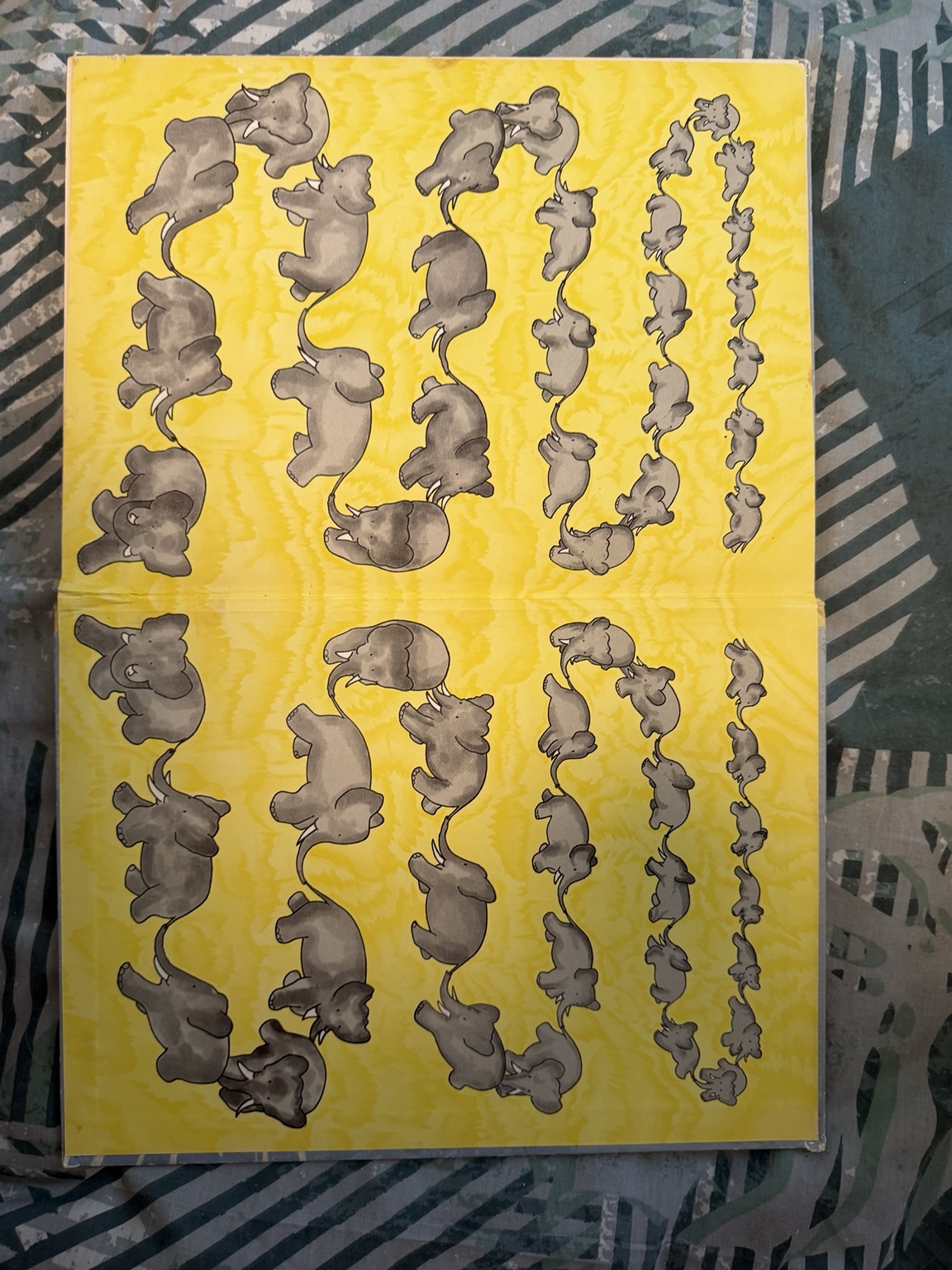 Full view of the yellow elephant-pattern endpapers